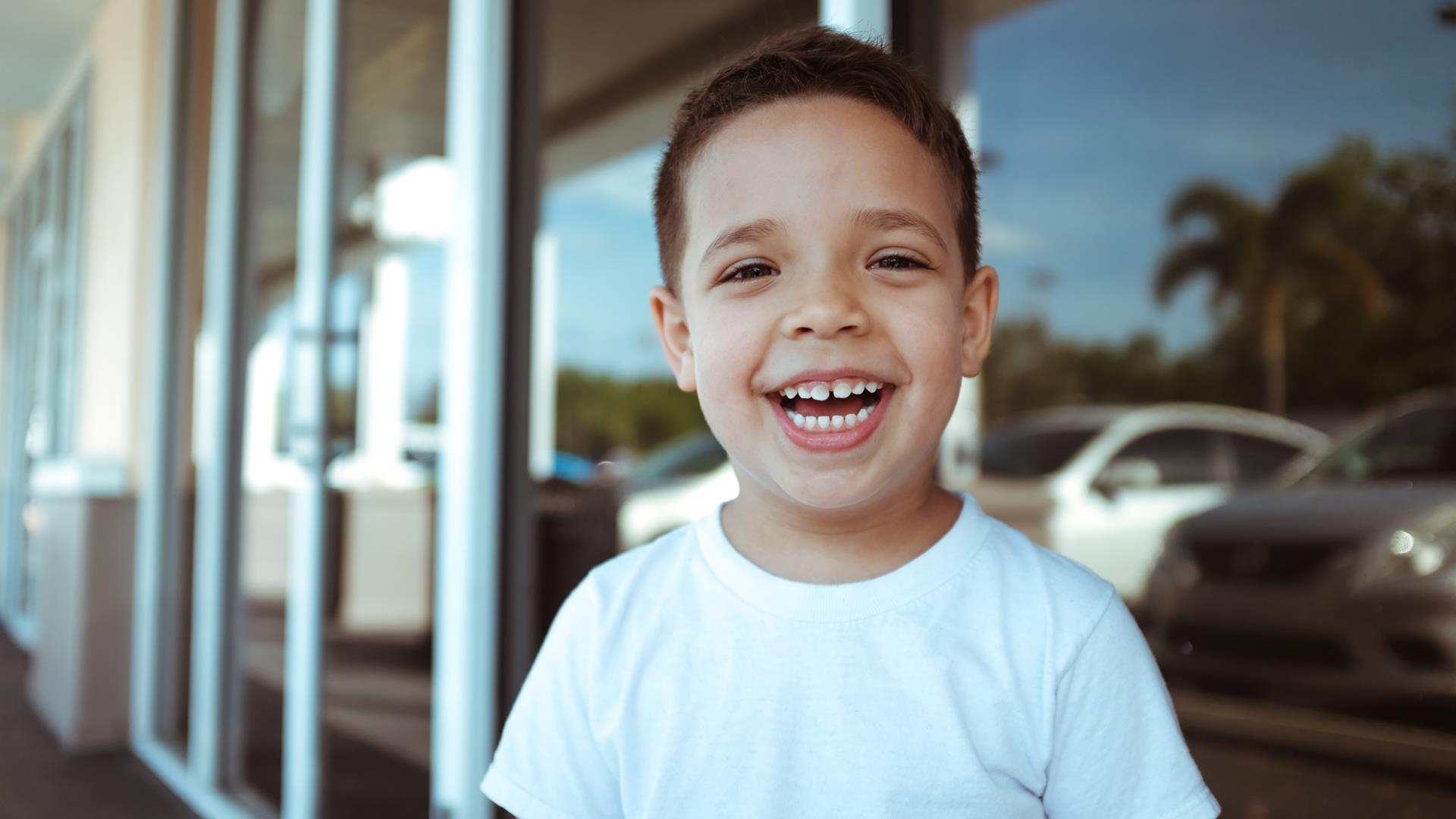 Pediatric dentist performing a pulpotomy on a baby tooth in Naples, FL